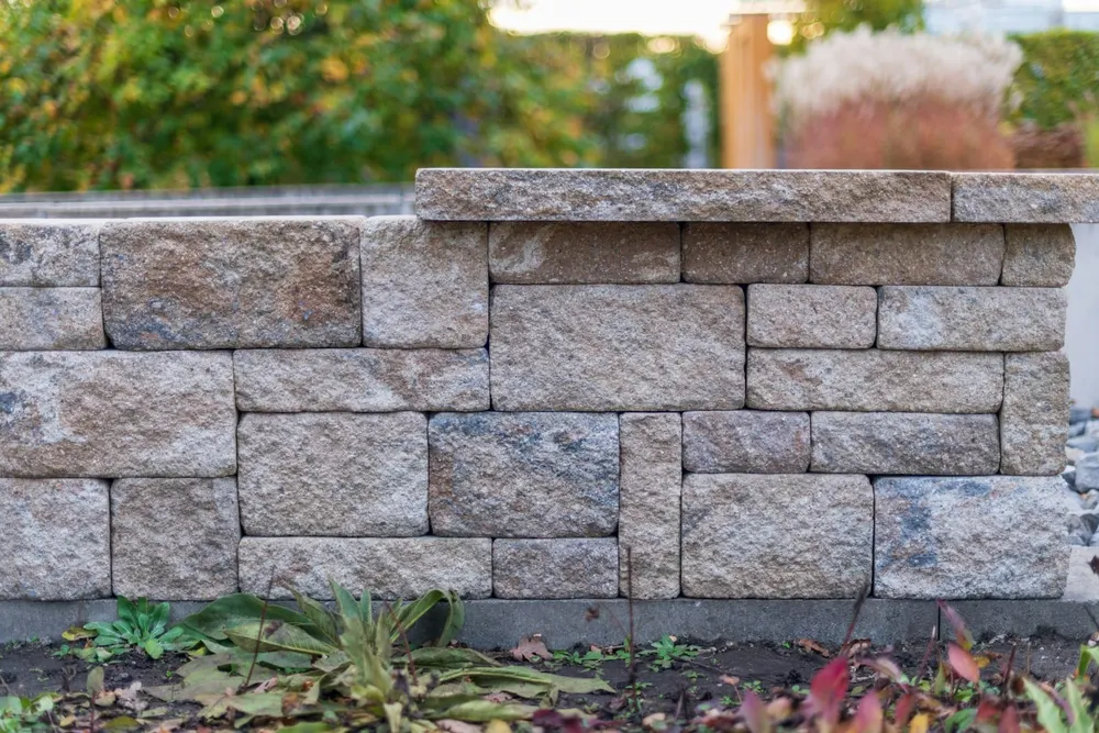 Curved retaining wall retaining a planted slope